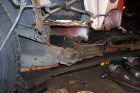 Rusted chassis side and cross member, and sill in close-up.